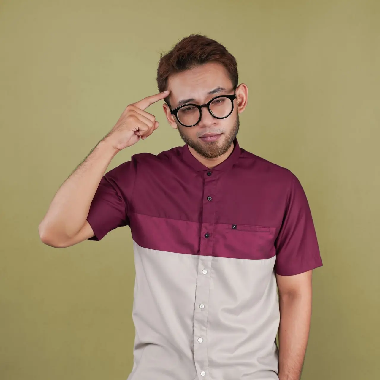 a man with glasses is posing for a picture